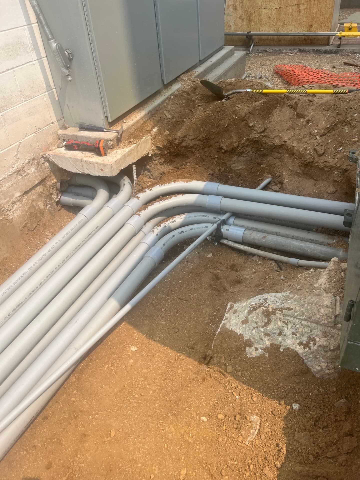 Conduit runs beneath an electrical cabinet