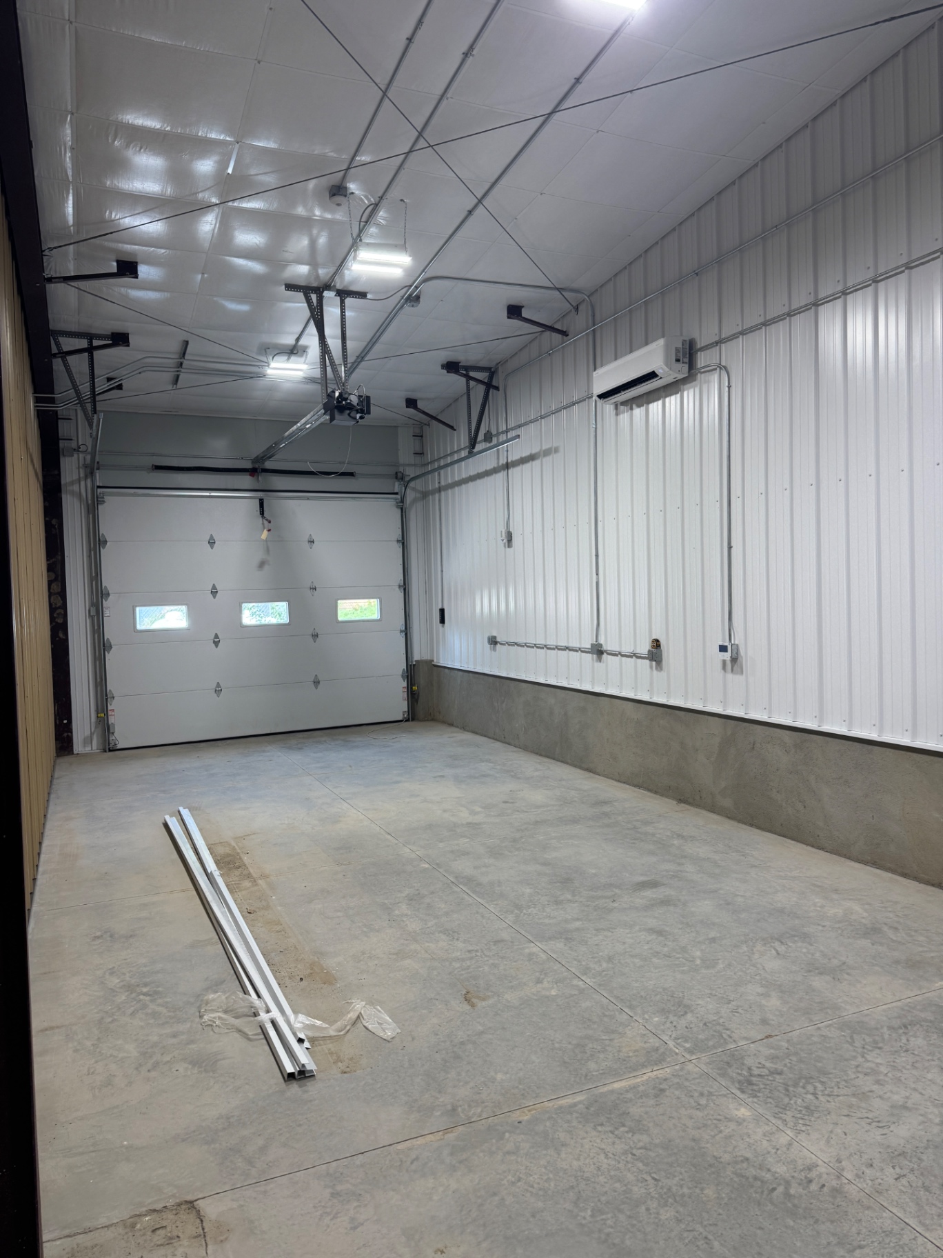 Garage bay with ceiling lights and an overhead door