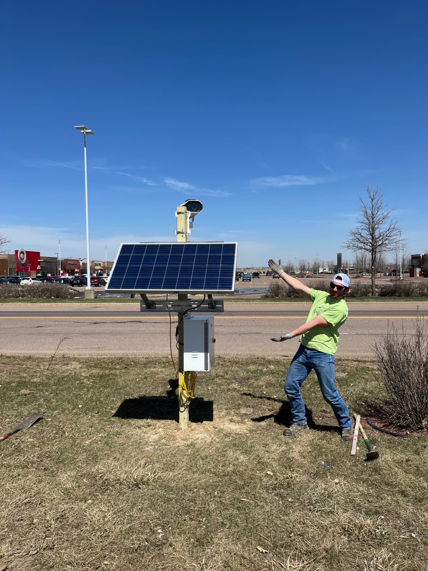 Worker beside a solar-powered outdoor installation