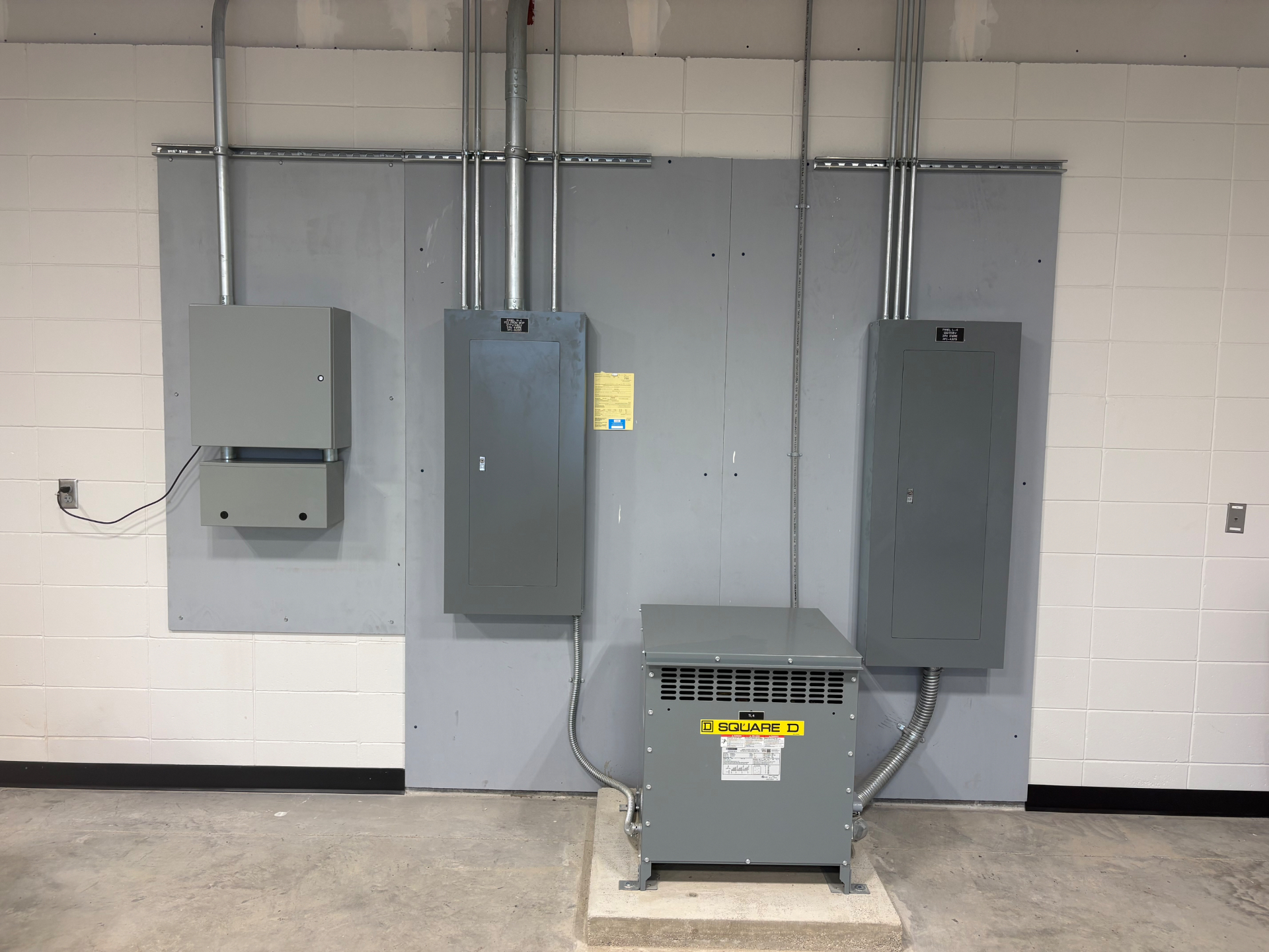 Electrical panels and a transformer installed in an equipment room